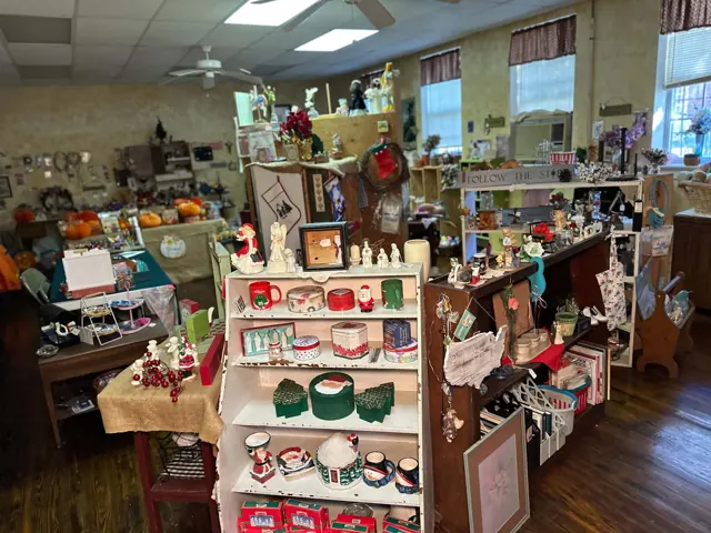 Shelves and tables hold mugs, figurines, holiday decorations, and other small home goods.