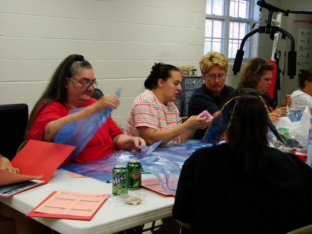 Adults taking part in a table activity in a classroom.