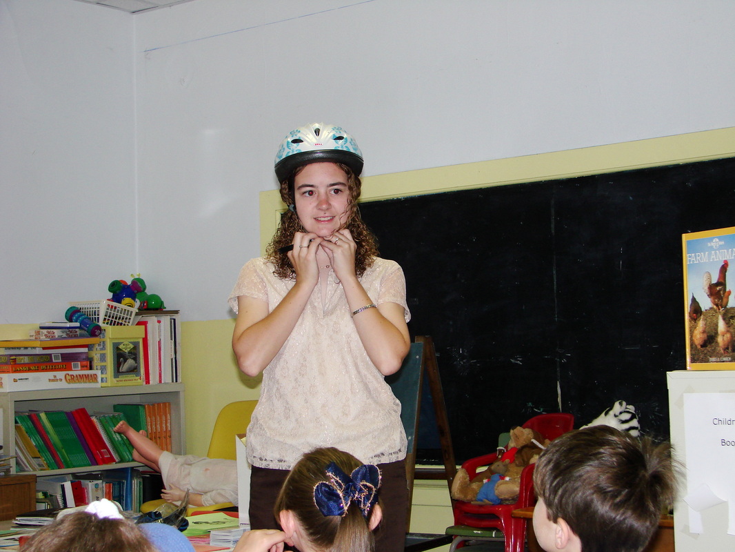 A participant wearing a bicycle helmet during a classroom activity.
