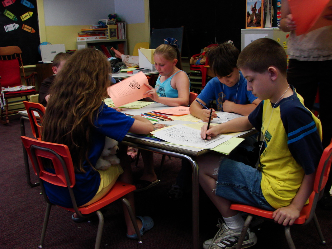 Children working together on a project at a classroom table.