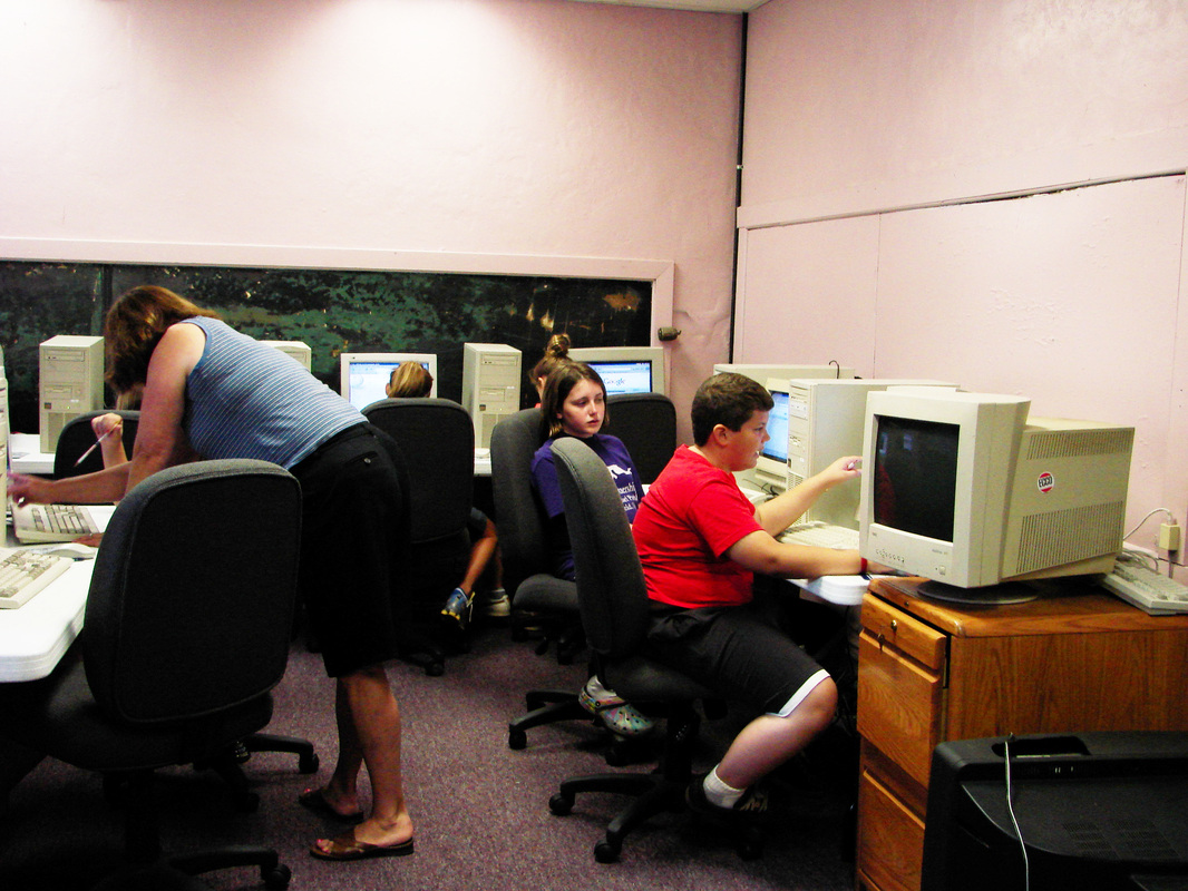 People using desktop computers in a classroom.